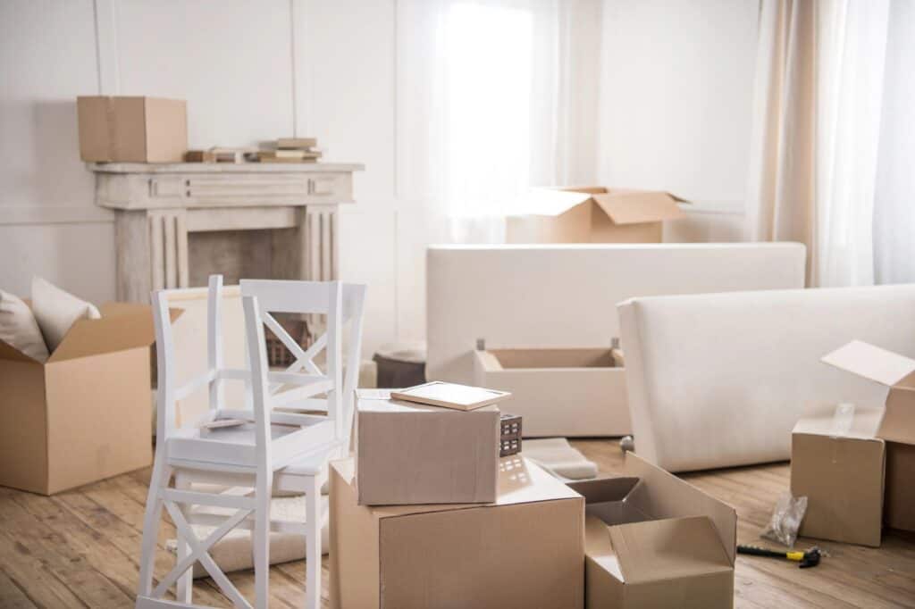 A living room with boxes to unpack after moving in