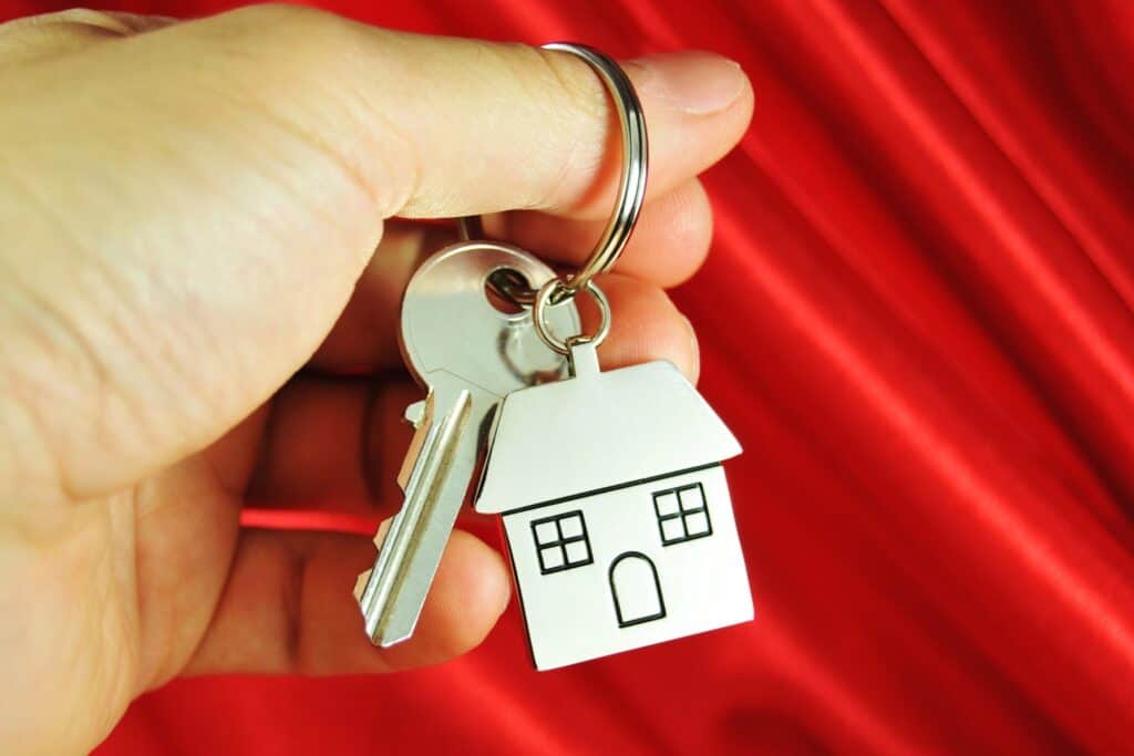 A house key with keychain in the concept of moving houses