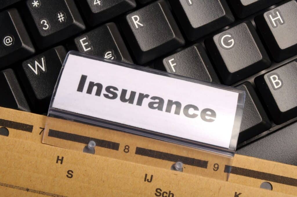 An Insurance folder on top of a keyboard