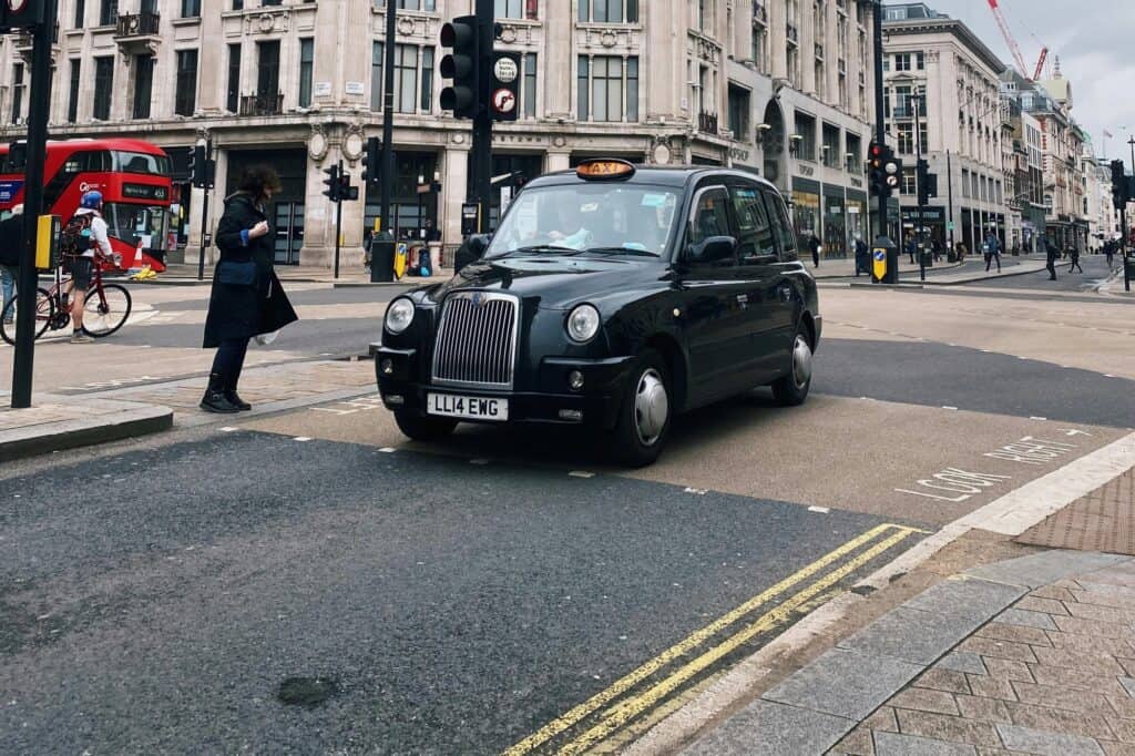 Black cab on the street picking up a passenger