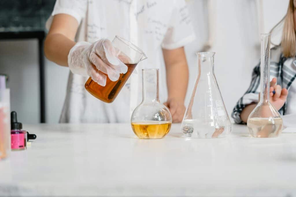 Cropped image of students in the laboratory working on an experiment