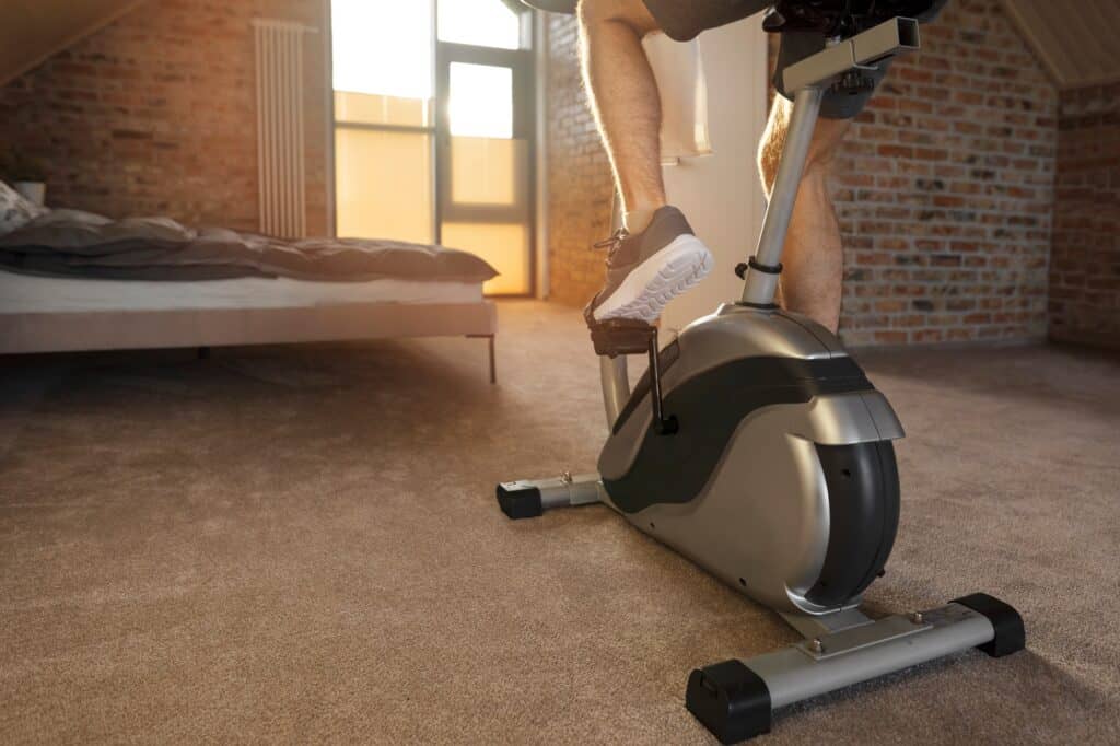 Cropped image of a man using a stationary bike